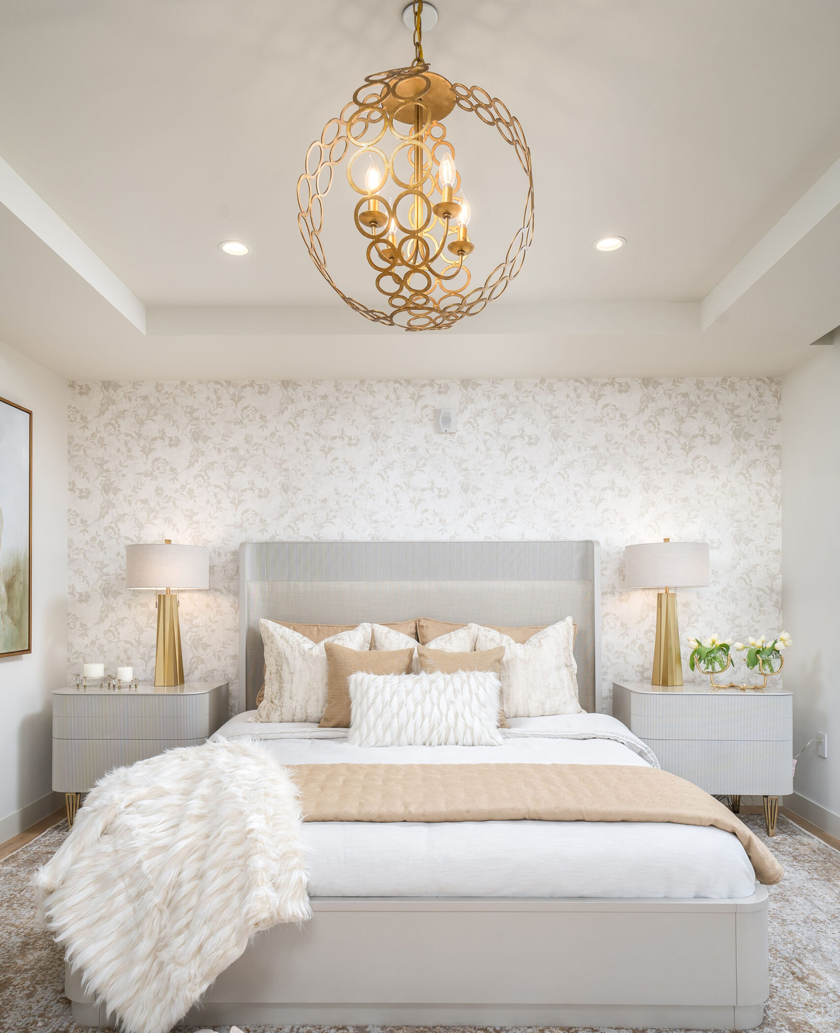 Luxury bedroom with white bedsheets and gold chandelier